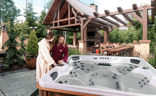 A couple setting up a hot tub